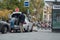 Man putting away his suitcase in taxi trunk