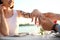 Man putting beautiful engagement ring on hand of his beloved outdoors