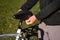 Man putting black rain cover on the bicycle saddle. Bicycle waterproof seat cover. Bike seat care