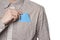 Man putting blue envelope in his shirt pocket