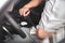 Man putting car seat belt before driving, close up at belt buckle, safe drive concept