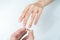 Man putting diamond ring on woman hand over white background