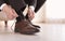 Man putting on elegant leather shoes indoors,