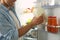 Man putting gallon of milk into refrigerator in kitchen