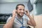 Man putting on headphones while sitting at workplace