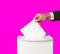 Man putting his vote into ballot box on bright pink background, closeup