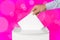 Man putting his vote into ballot box on pink background, closeup