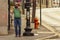 man is putting on mask before crossing road to minimize contact