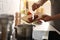 Man putting meat into pot to make bouillon in kitchen, closeup. Homemade recipe