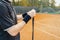 Man putting new grip tape on tennis racket. Wrapping finishing tape on racquet.