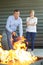 Man putting out controlled fire with extinguisher