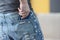 Man putting phone in his jeans pocket closeup