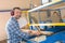 Man putting plank wood through machine