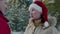 Man putting santa hat on his beautiful smiling wife