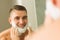 Man putting shaving foam on face