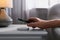 Man putting smartphone on wireless charger in room