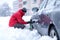 Man putting snow chains on car tire