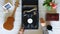 Man putting stylus with needle on vinyl record. Top view on male hands turning on vintage gramophone at white table