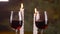 Man putting on table glass with red wine with candle light for romantic dinner