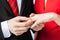 Man putting wedding ring on woman hand