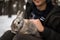 Man with a rabbit. The boy gently hugs a gray fluffy rabbit, a happy childhood