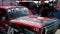 Man racer, rubs red sports car covered with stickers for street drift racing