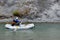 Man rafting on whitewater with his dog in Ruinaulta, or Rhine Gorge in Switzerland.