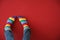 Man with rainbow socks on color background