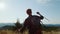 Man raising hands in air during hike in mountains. Happy hiker feeling freedom