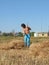 A man rakes the straw. Farmer in field