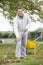 Man raking leaves in garden