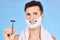 Man, razor and shaving with cream, happy and skincare while grooming beard, morning and cosmetic in blue studio