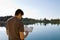 Man Reading Bible By Lake