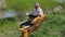 Man reading book on the bench near river