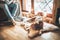 Man reading book on the cozy couch near slipping his beagle dog on sheepskin in cozy home atmosphere. Peaceful moments of cozy