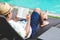 Man reading book near swimming pool. Relax concept.