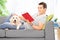 Man reading book and relaxing with a puppy at home