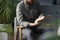 Man reading book while sitting on grey armchair