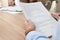 Man reading employment agreement at table in office, closeup. Signing contract