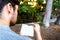 A man reads a relaxed novel sitting in a park at sunset, lover of books