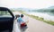 Man reads roads map sitting near his cabriolet on picturesque mo