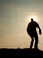 Man ready to jump. Adult crazy man is jumping on colorful sky background.Silhouette of man and beautiful sunset sky