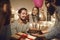 Man receives greetings and a delicious chocolate cake with burning candles given to him by friends.