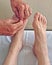 Man receiving acupuncture treatment in feet