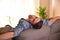 Man reclining comfortably on couch rear view