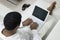 Man reclining on sofa using laptop high angle view