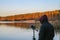 Man records the sounds of nature on a recorder on the lake