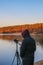 Man records the sounds of nature on a recorder on the lake