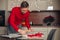 Man in red famously uses rolling pin to bake cookies and roll out dough at home in kitchen. Ready to surprise friends and family