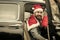 Man in red hat deliver xmas gifts in retro car